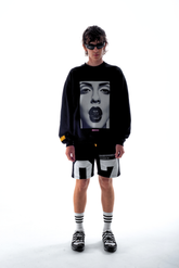 Model in the Haresquare Black sweatshirt with graphic print, styled with Haresquare black shorts – unisex luxury streetwear from Ireland.