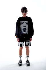 Model in the Haresquare Black sweatshirt with graphic print, styled with Haresquare black shorts – unisex luxury streetwear from Ireland.