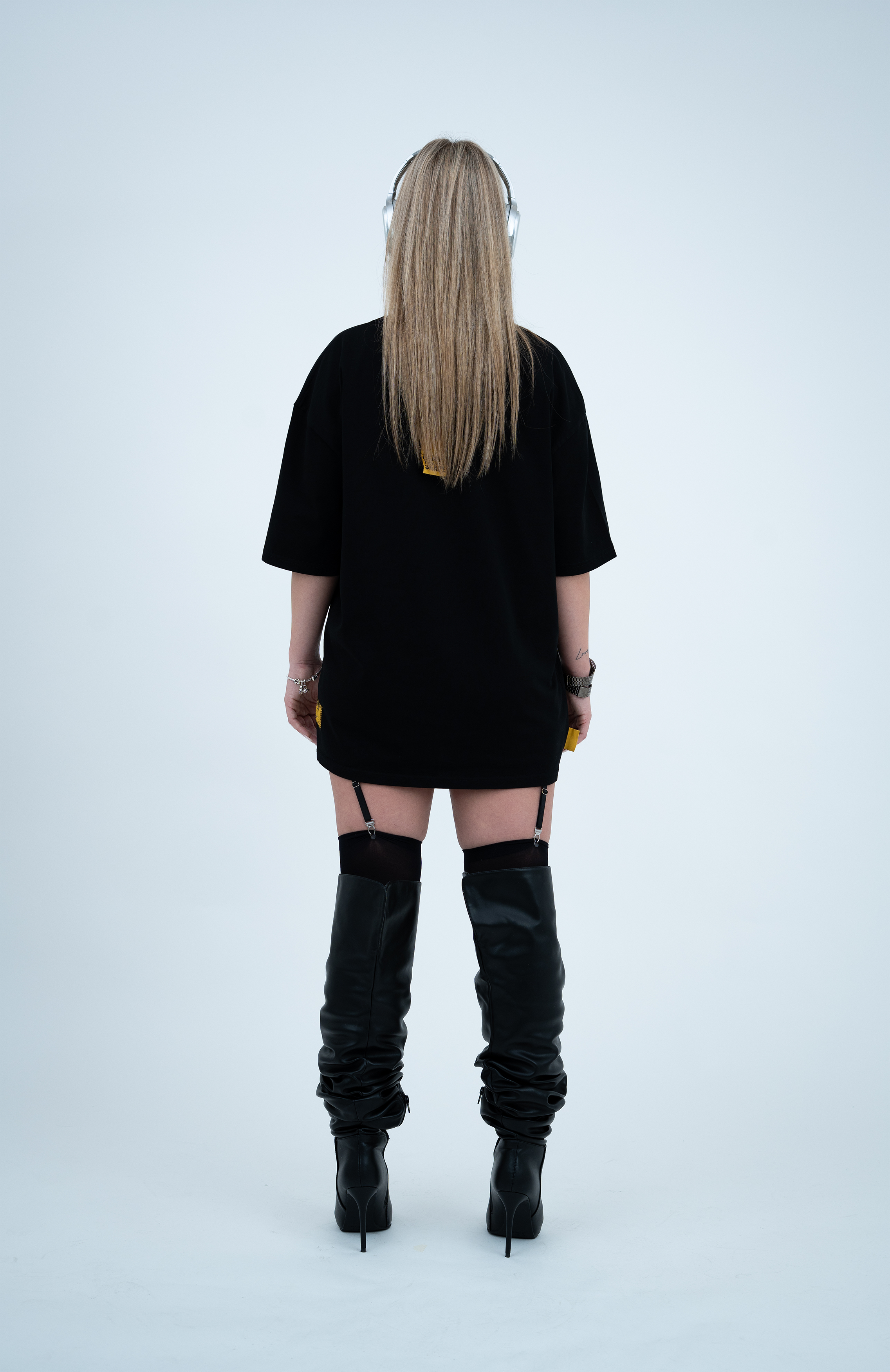 Model in the Haresquare black t-shirt with a bold graphic print, styled with Haresquare mini skirt, designer boots in black & Luxury sunglasses – unisex luxury streetwear from Ireland.