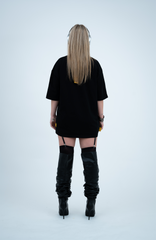 Model in the Haresquare black t-shirt with a bold graphic print, styled with Haresquare mini skirt, designer boots in black & Luxury sunglasses – unisex luxury streetwear from Ireland.