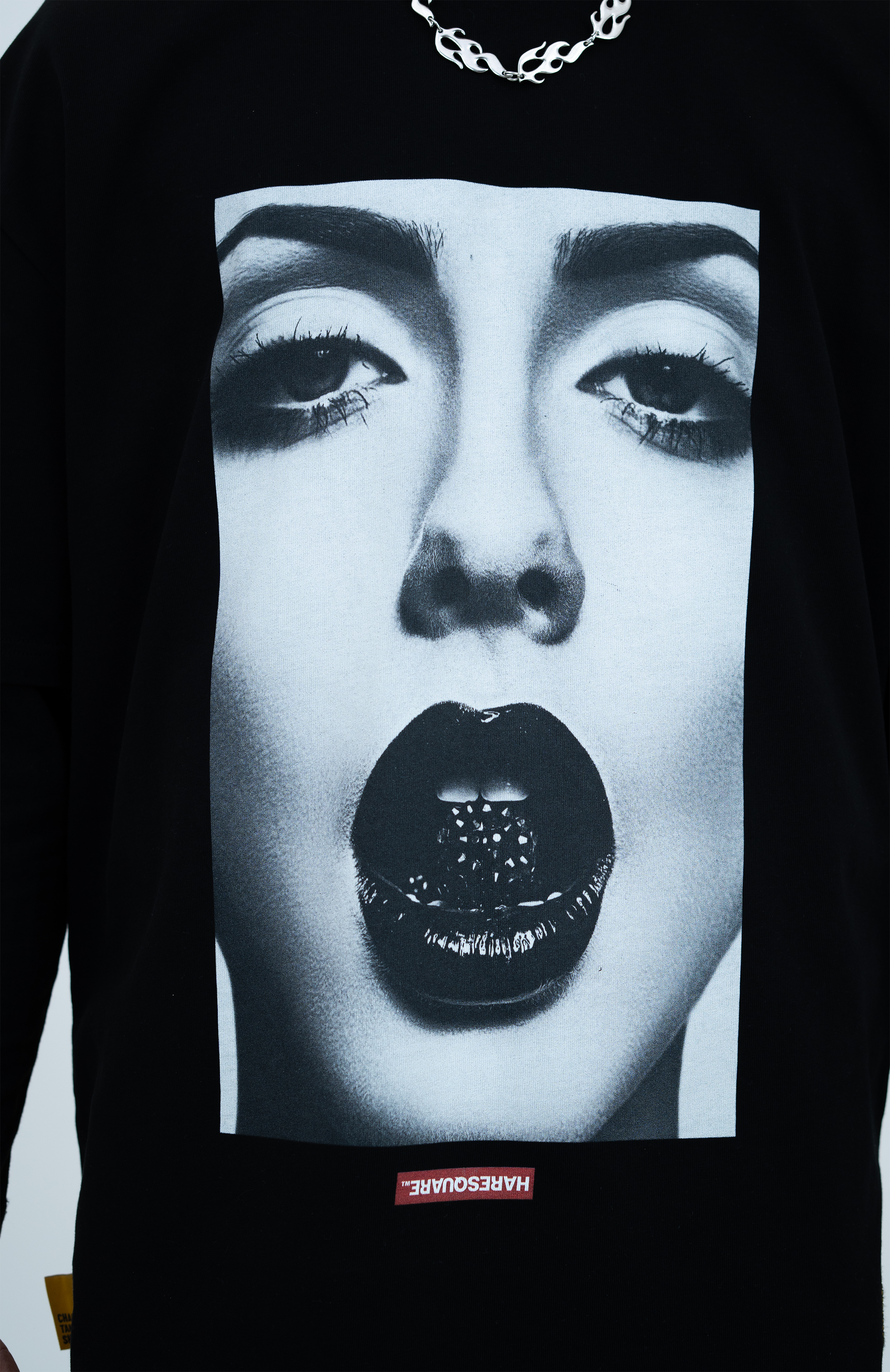 Model in the Haresquare black tshirt with a bold graphic print, styled with Haresquare Shorts in black & Luxury sunglasses – unisex luxury streetwear from Ireland.