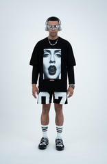 Model in the Haresquare black t-shirt with a bold graphic print, styled with Haresquare Shorts in black & Luxury sunglasses – unisex luxury streetwear from Ireland.