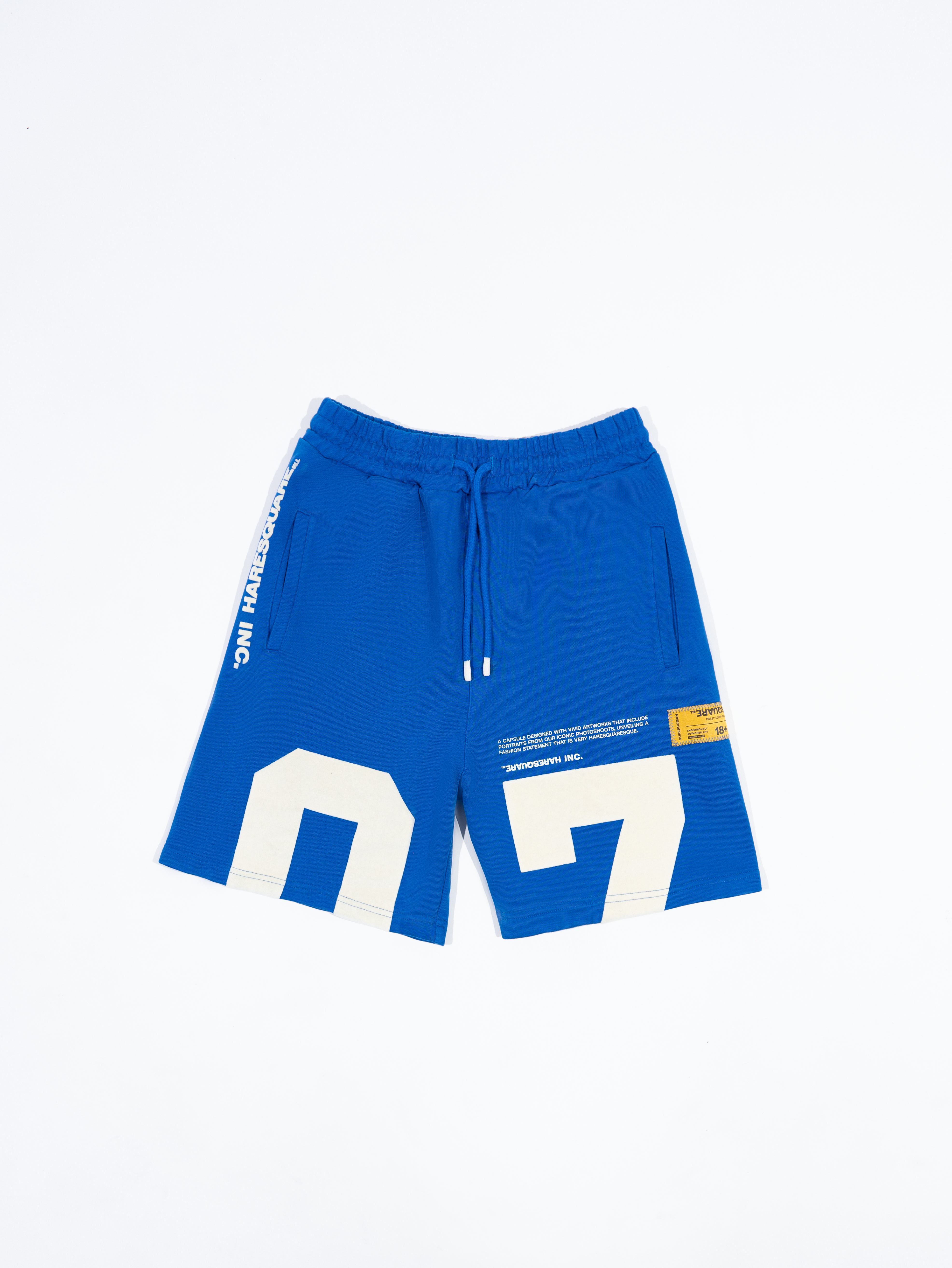 Close-up of Haresquare black shorts with a white print – unisex luxury streetwear from Ireland.