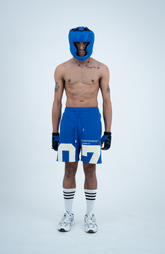 Model in the Haresquare Nautical Blue shorts with a White print, styled with sports accessory – unisex luxury streetwear from Ireland.