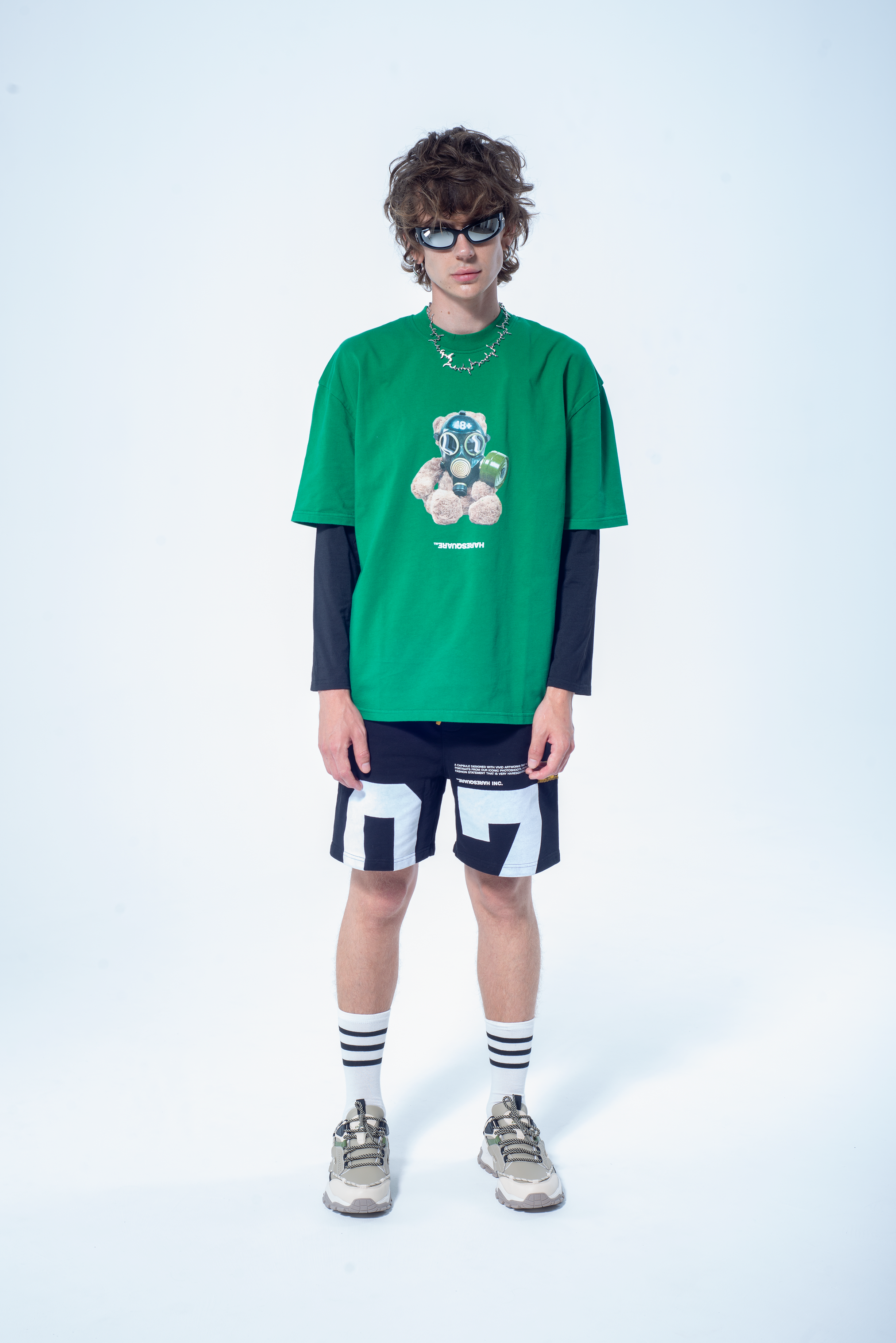 Model in the Haresquare Green t-shirt with breathless bear graphic print, styled with Haresquare black shorts – unisex luxury streetwear from Ireland.
