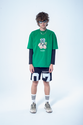 Model in the Haresquare Green t-shirt with breathless bear graphic print, styled with Haresquare black shorts – unisex luxury streetwear from Ireland.