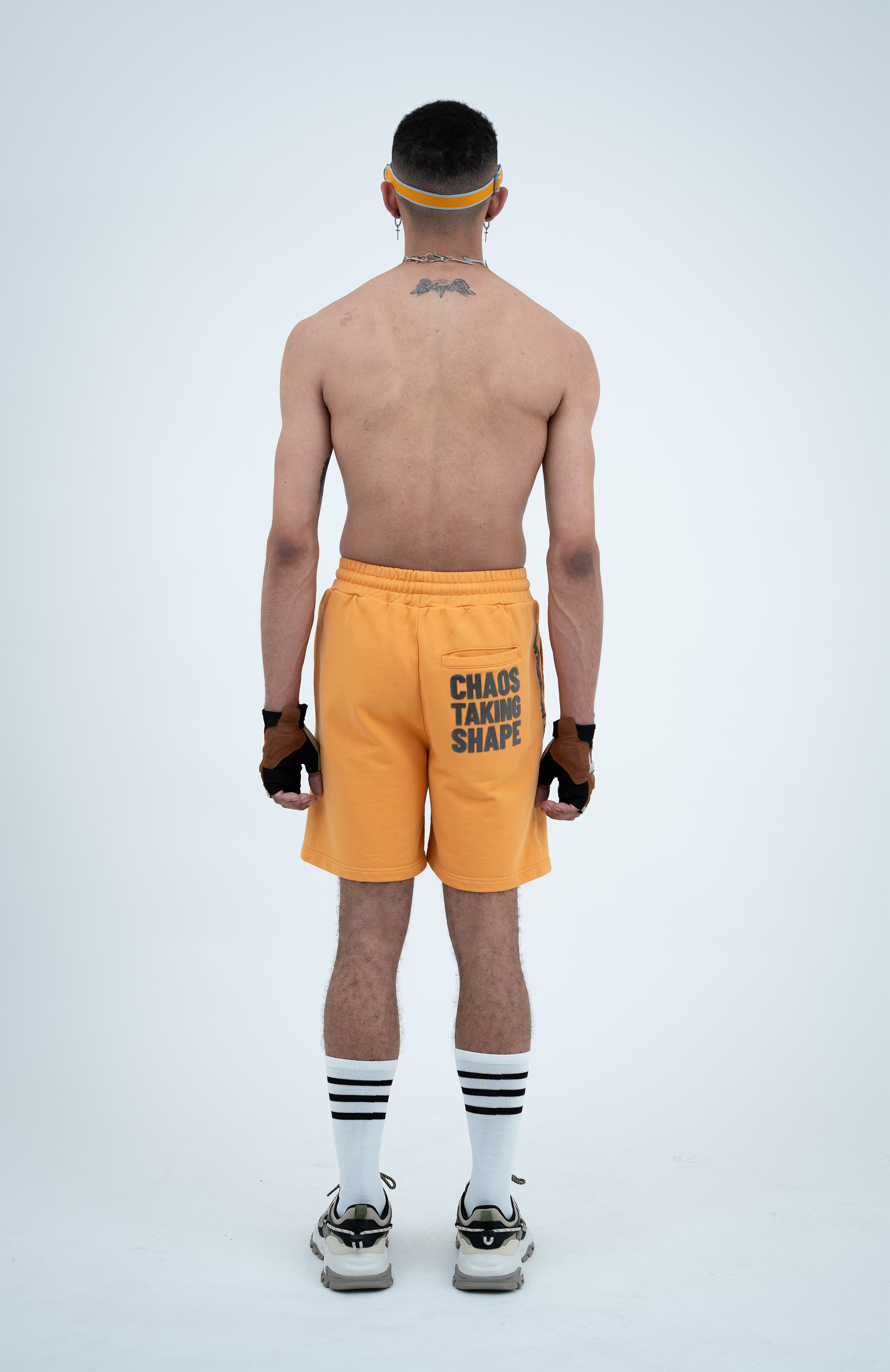 Model in the Haresquare Apricot Tan shorts with a Grey print, styled with Haresquare luxury sunglasses – unisex luxury streetwear from Ireland.