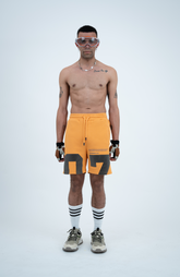 Model in the Haresquare Apricot Tan shorts with a Grey print, styled with Haresquare luxury sunglasses – unisex luxury streetwear from Ireland.