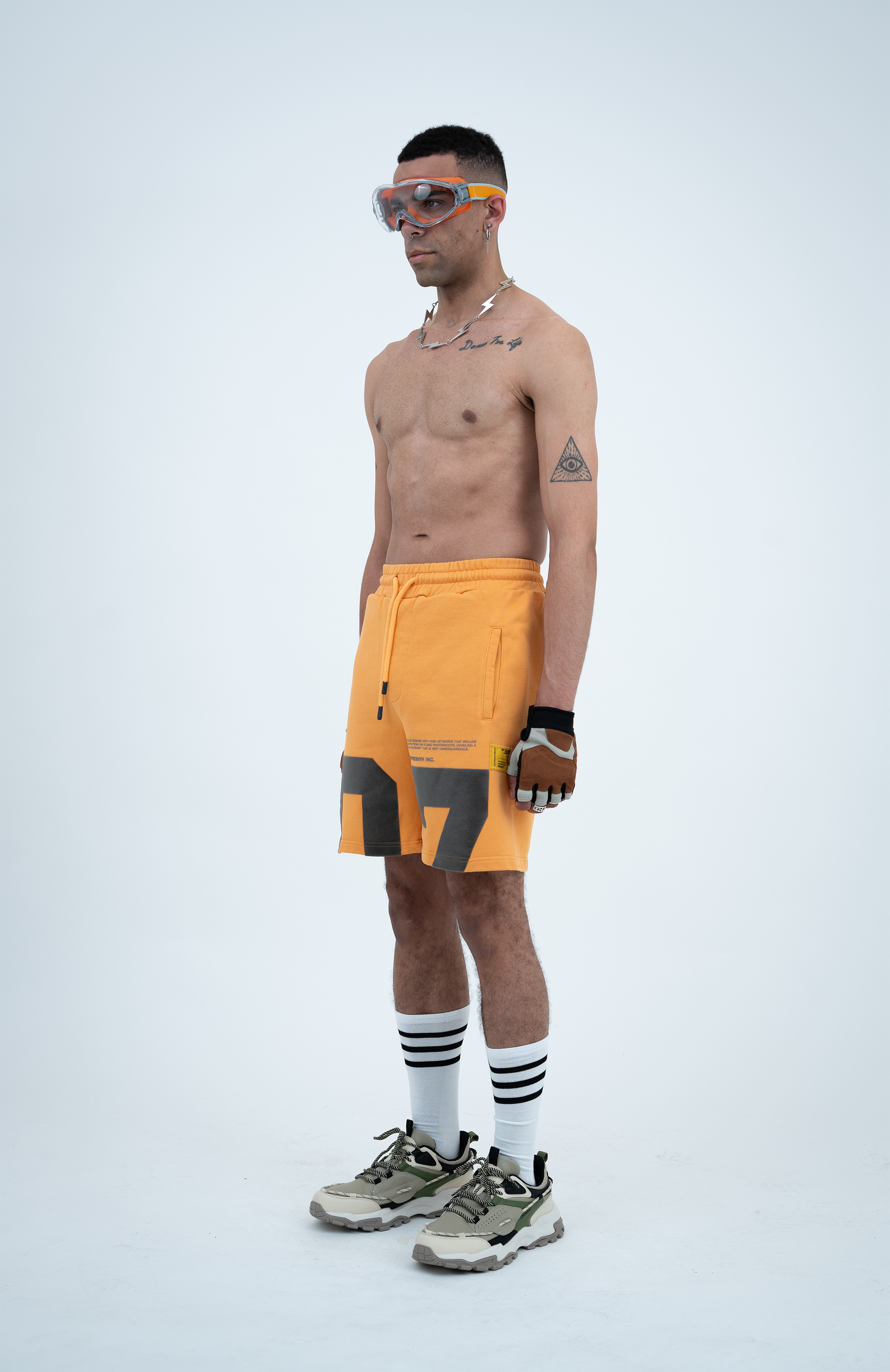 Model in the Haresquare Apricot Tan shorts with a Grey print, styled with Haresquare luxury sunglasses – unisex luxury streetwear from Ireland.