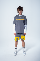 Model in the Haresquare steel grey tshirt with a yellow print, styled with Haresquare shorts in grey – unisex luxury streetwear from Ireland.