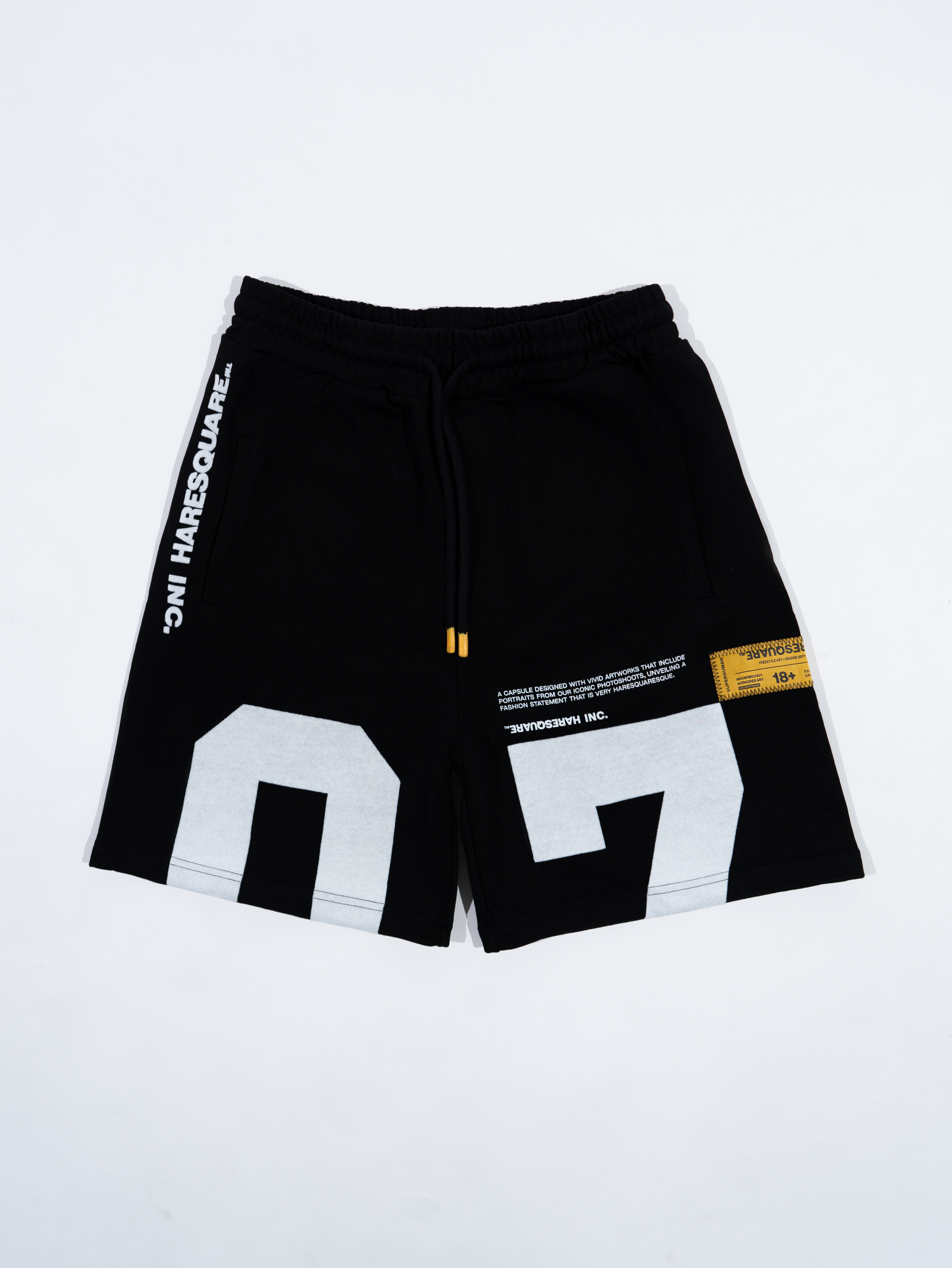 Close-up of Haresquare black shorts with a white print – unisex luxury streetwear from Ireland.