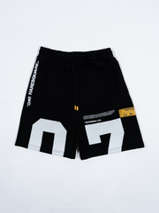 Close-up of Haresquare black shorts with a white print – unisex luxury streetwear from Ireland.