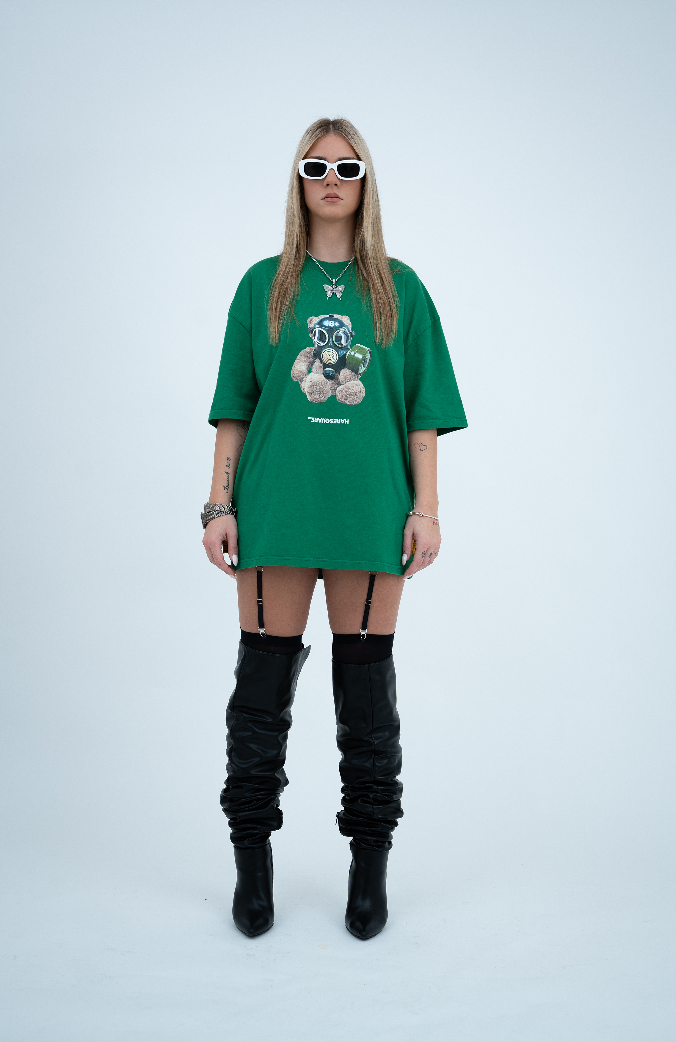 Model in the Haresquare Green tshirt with breathless bear graphic print, styled with Haresquare mini skirt and designer boots – unisex luxury streetwear from Ireland.