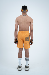 Model in the Haresquare Apricot Tan shorts with a Grey print, styled with Haresquare luxury sunglasses – unisex luxury streetwear from Ireland.