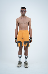 Model in the Haresquare Apricot Tan shorts with a Grey print, styled with Haresquare luxury sunglasses – unisex luxury streetwear from Ireland.