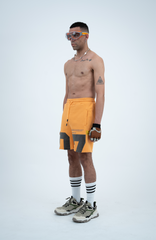 Model in the Haresquare Apricot Tan shorts with a Grey print, styled with Haresquare luxury sunglasses – unisex luxury streetwear from Ireland.