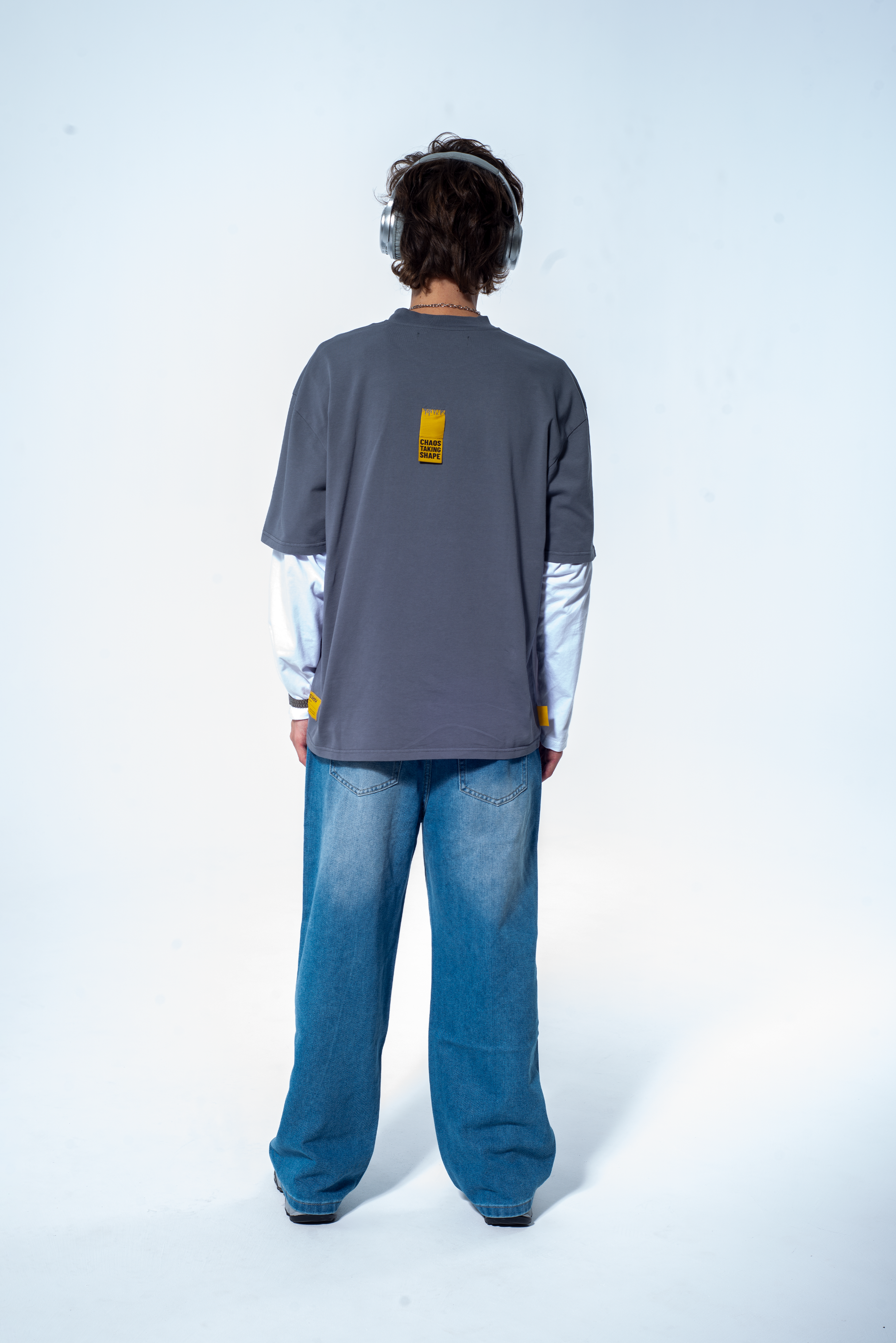 Model in the Haresquare Steel Grey tshirt with a bold graphic print, styled with Haresquare denim jeans in blue – unisex luxury streetwear from Ireland.