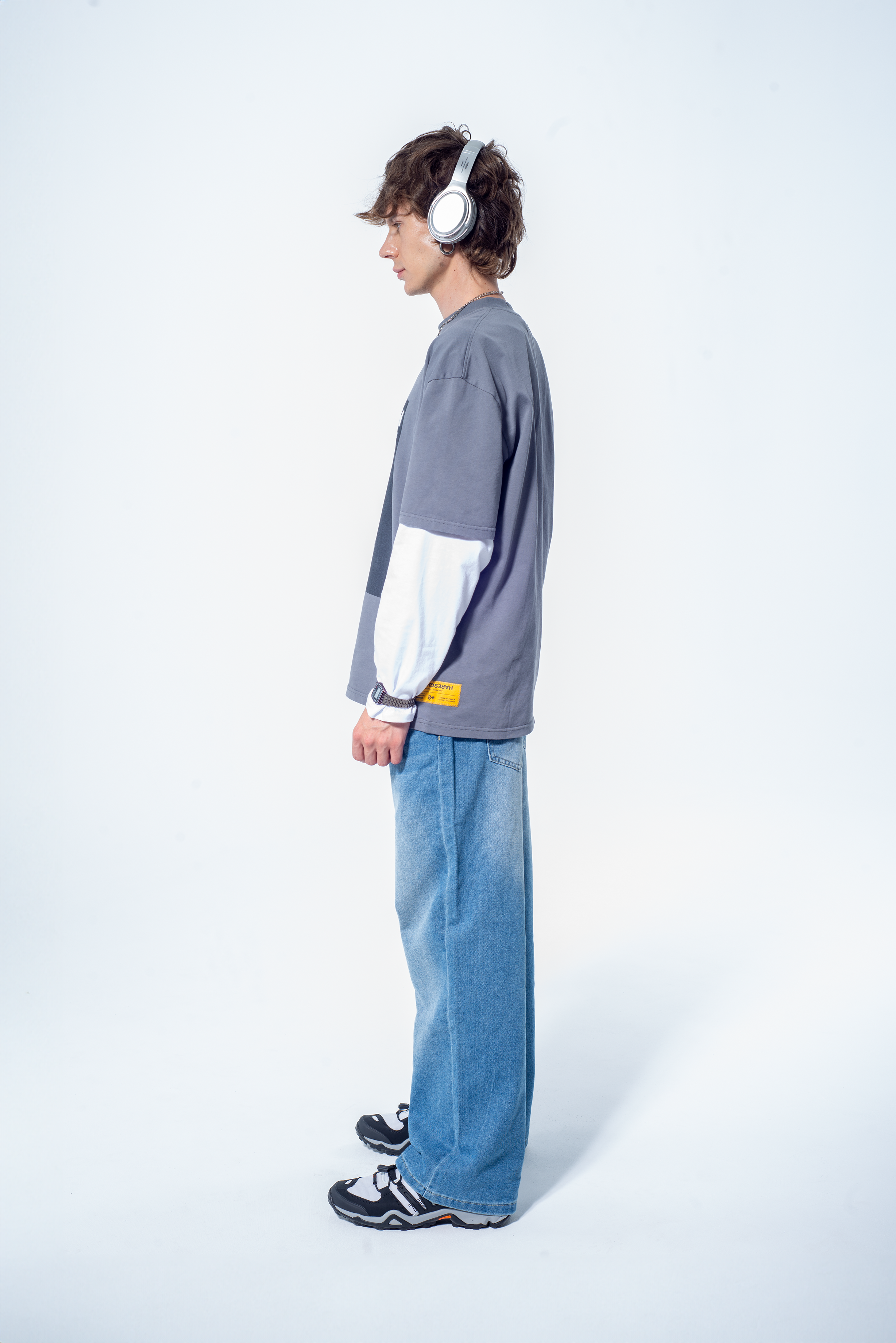 Model in the Haresquare Steel Grey tshirt with a bold graphic print, styled with Haresquare denim jeans in blue – unisex luxury streetwear from Ireland.