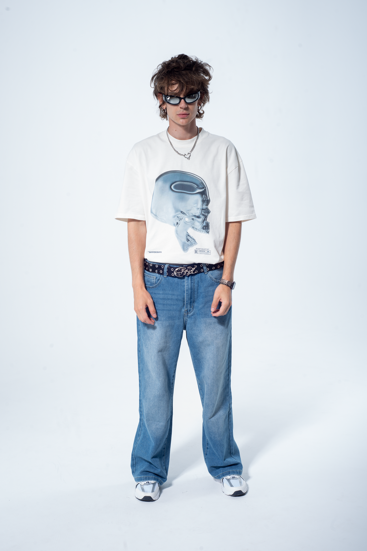 Model in the Haresquare vintage white tshirt with a Skull graphic print, styled with Haresquare blue denim jeans – unisex luxury streetwear from Ireland.
